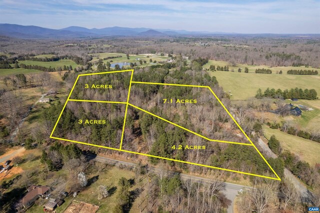 drone / aerial view featuring a mountain view and a rural view