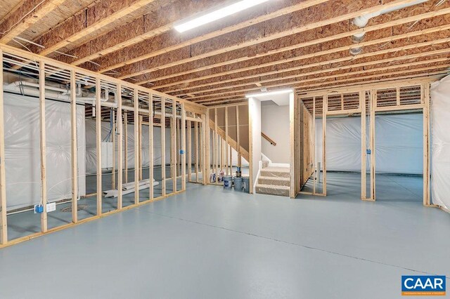 unfinished basement featuring stairway