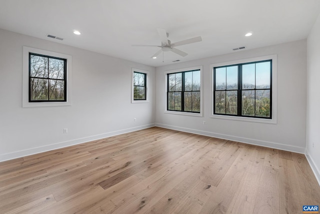 unfurnished room with recessed lighting, visible vents, light wood-style flooring, and baseboards