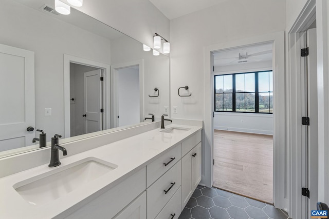 bathroom with double vanity, visible vents, tile patterned floors, and a sink