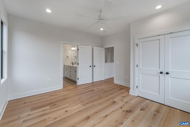 unfurnished bedroom with recessed lighting, ensuite bath, light wood-type flooring, and baseboards