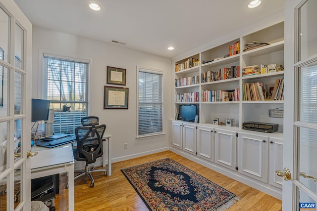 office featuring light wood finished floors, visible vents, recessed lighting, and baseboards