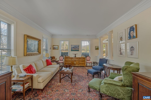 living area with crown molding and ornate columns