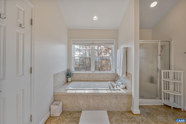 full bathroom featuring a shower stall and a bath