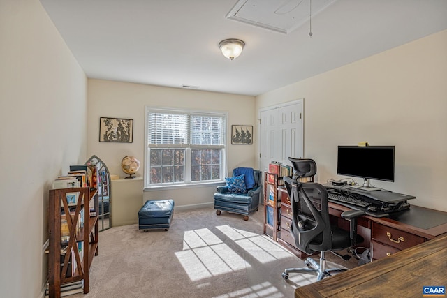 office featuring baseboards, attic access, and carpet