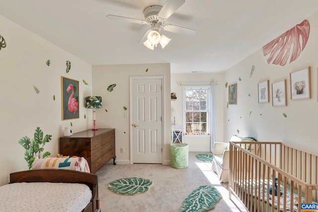 carpeted bedroom featuring baseboards and ceiling fan