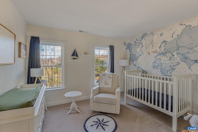 carpeted bedroom featuring a nursery area, visible vents, and baseboards