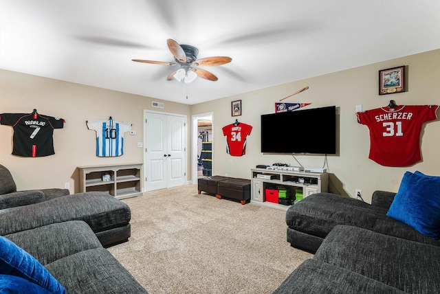 living room featuring carpet floors, a ceiling fan, and visible vents