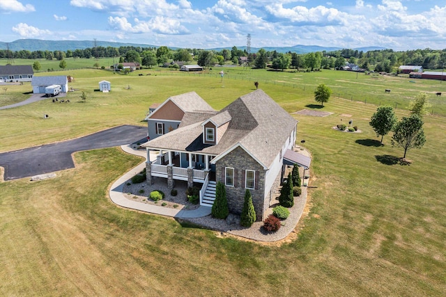 drone / aerial view with a mountain view and a rural view