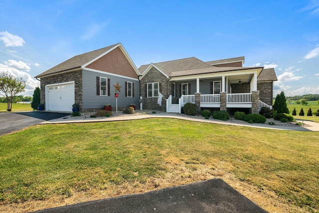 view of front of property featuring a porch, a front yard, driveway, and stone siding