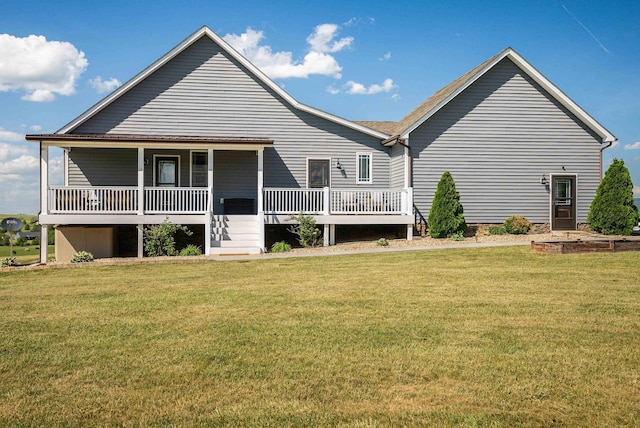 rear view of property featuring a lawn and covered porch
