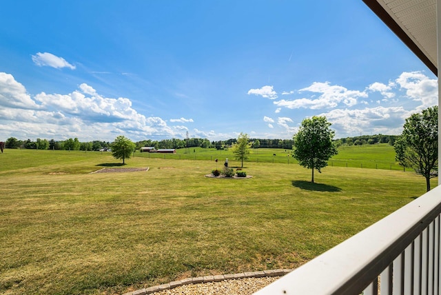 view of yard featuring fence and a rural view