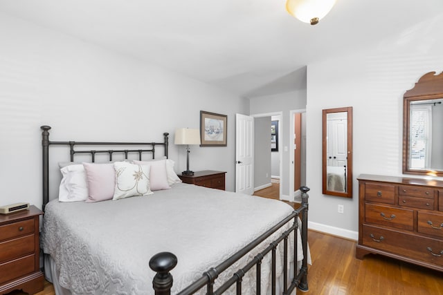 bedroom with dark hardwood / wood-style flooring