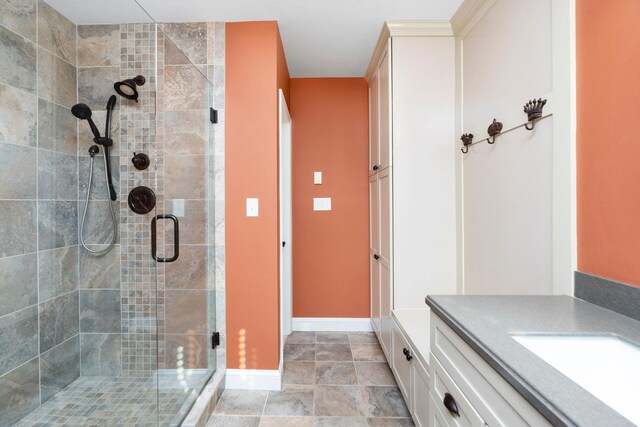 bathroom with vanity and a shower with shower door