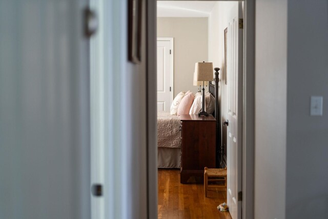 hallway with hardwood / wood-style flooring