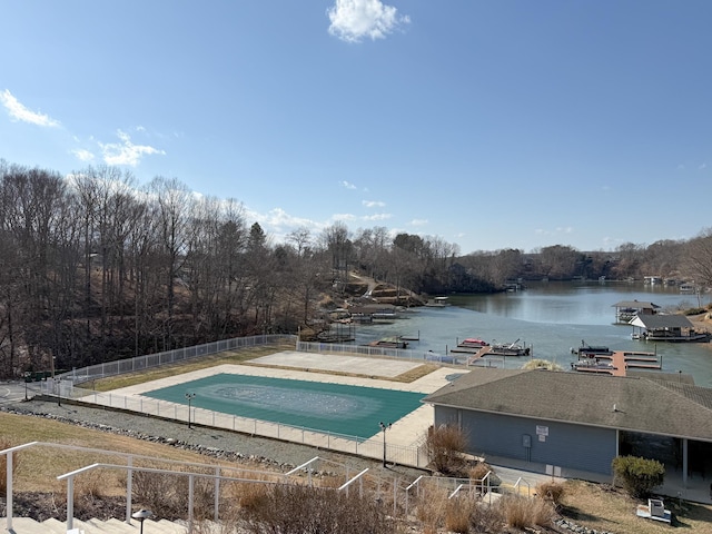 view of swimming pool with a water view