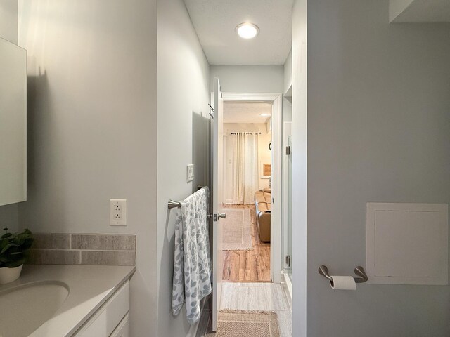 bathroom featuring hardwood / wood-style flooring and vanity