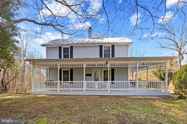 view of front of house featuring covered porch and a chimney