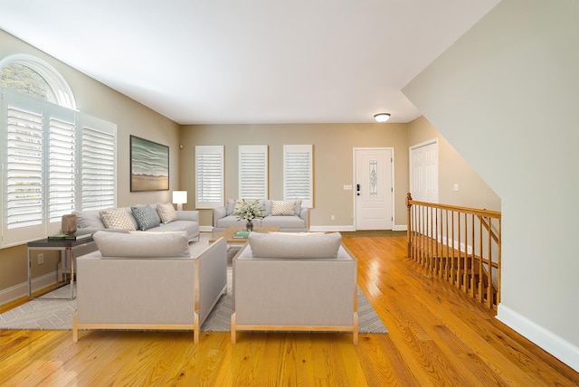 living room with light hardwood / wood-style flooring and a healthy amount of sunlight