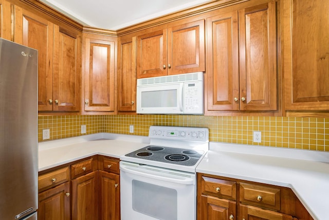 kitchen featuring backsplash and white appliances