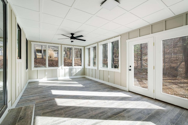 unfurnished sunroom with a paneled ceiling and ceiling fan