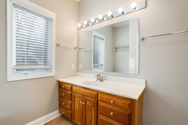 bathroom featuring vanity, tile patterned flooring, and a healthy amount of sunlight