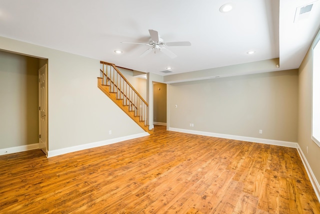 basement featuring ceiling fan and light wood-type flooring