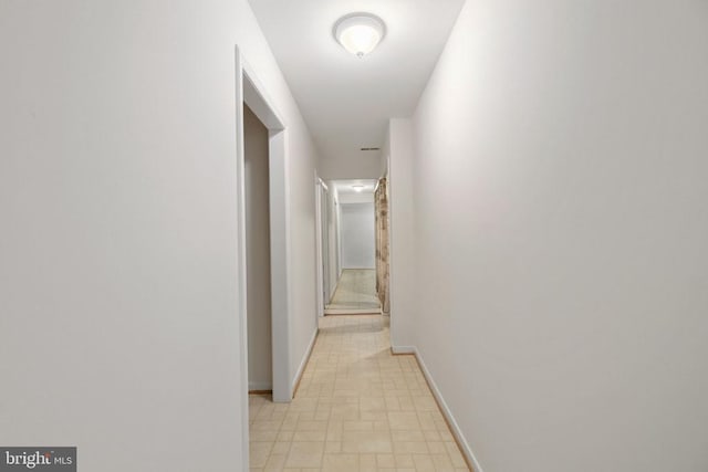 corridor featuring baseboards