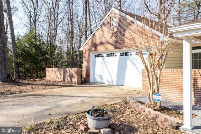 garage with driveway and fence