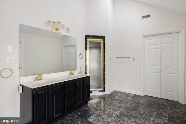 bathroom featuring a closet, visible vents, a sink, and double vanity