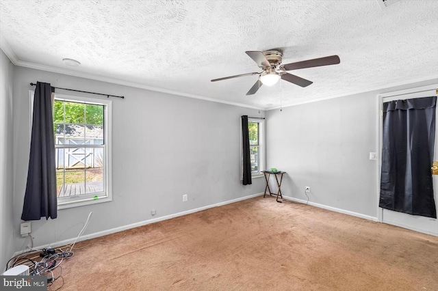 spare room featuring carpet flooring, a ceiling fan, and a healthy amount of sunlight
