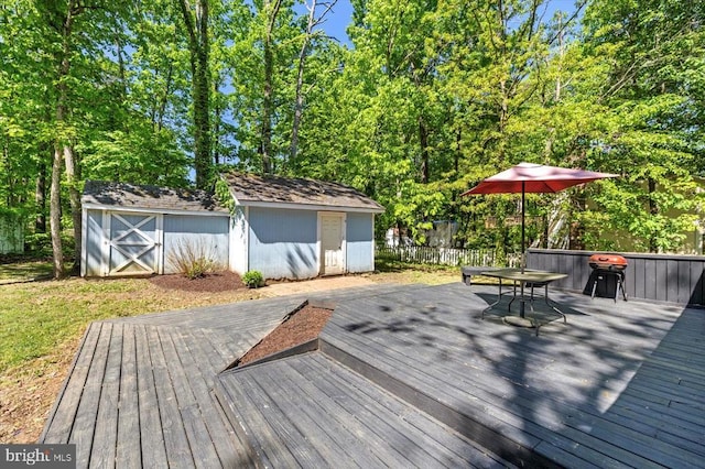 wooden terrace featuring a storage shed, an outdoor structure, outdoor dining area, and a grill