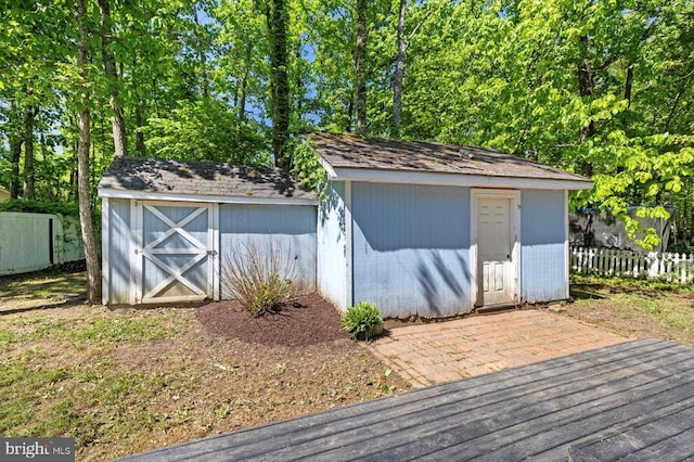 view of shed featuring fence