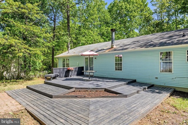 exterior space featuring a deck and a jacuzzi