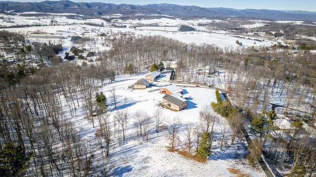 snowy aerial view with a mountain view