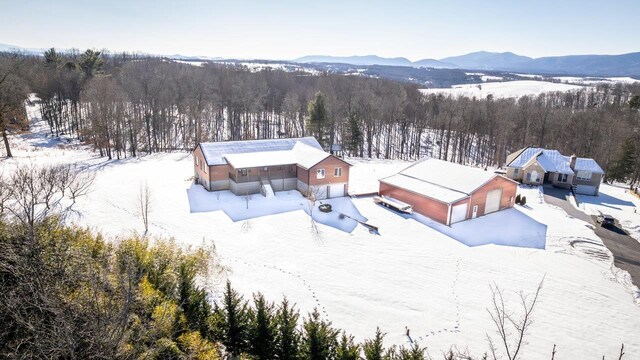 snowy aerial view with a mountain view