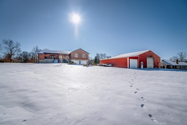 snowy yard featuring a garage