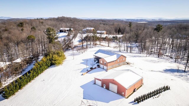 snowy aerial view featuring a mountain view