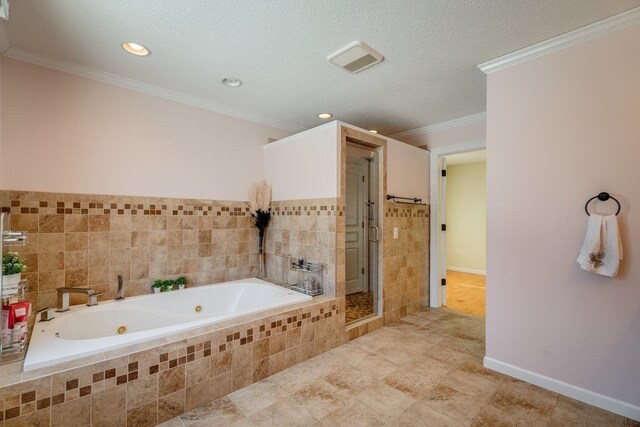 bathroom with ornamental molding, plus walk in shower, and a textured ceiling