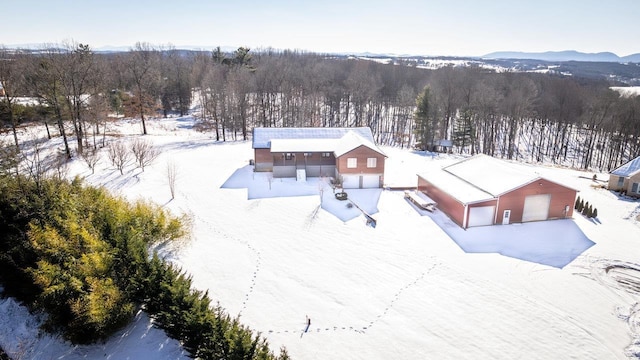 snowy aerial view featuring a mountain view