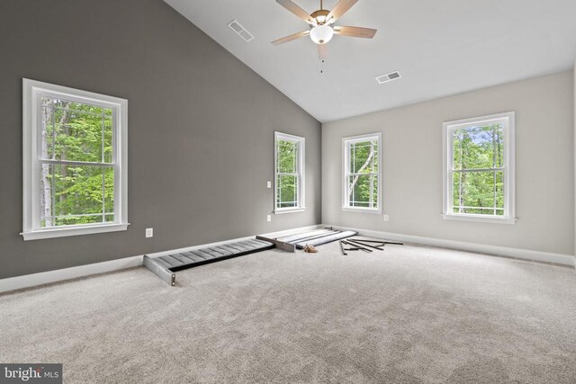 carpeted empty room featuring ceiling fan and high vaulted ceiling