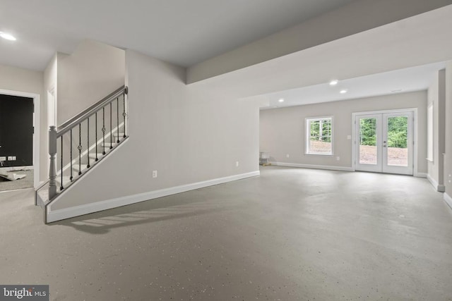 unfurnished living room featuring french doors