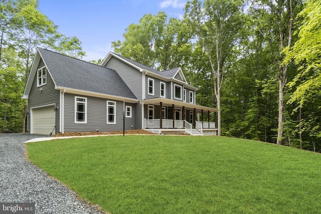 view of front of home with a porch, a garage, and a front yard