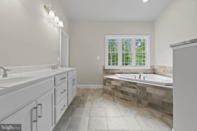 bathroom featuring vanity and tiled bath