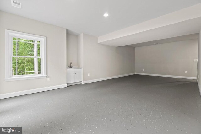 unfurnished living room with sink