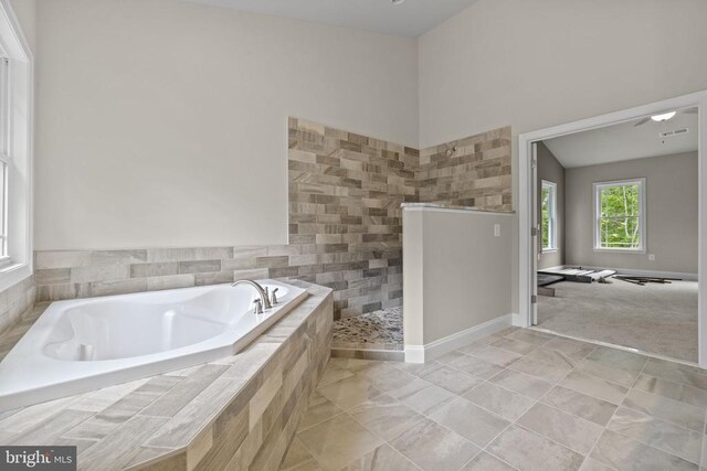 bathroom featuring tile patterned floors and independent shower and bath