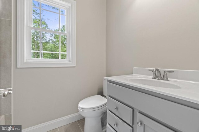 bathroom featuring tile patterned flooring, vanity, and toilet