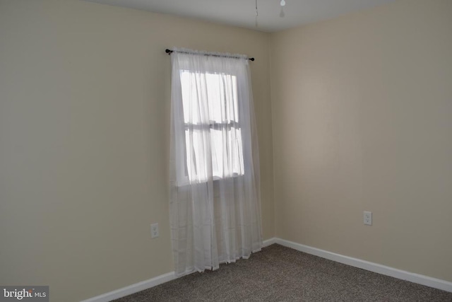 carpeted empty room with baseboards