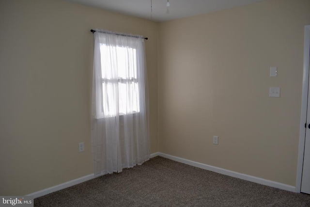 carpeted spare room with baseboards