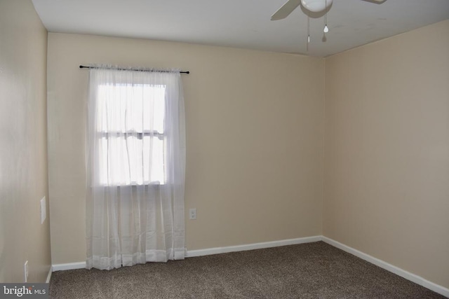 carpeted empty room with baseboards and a ceiling fan